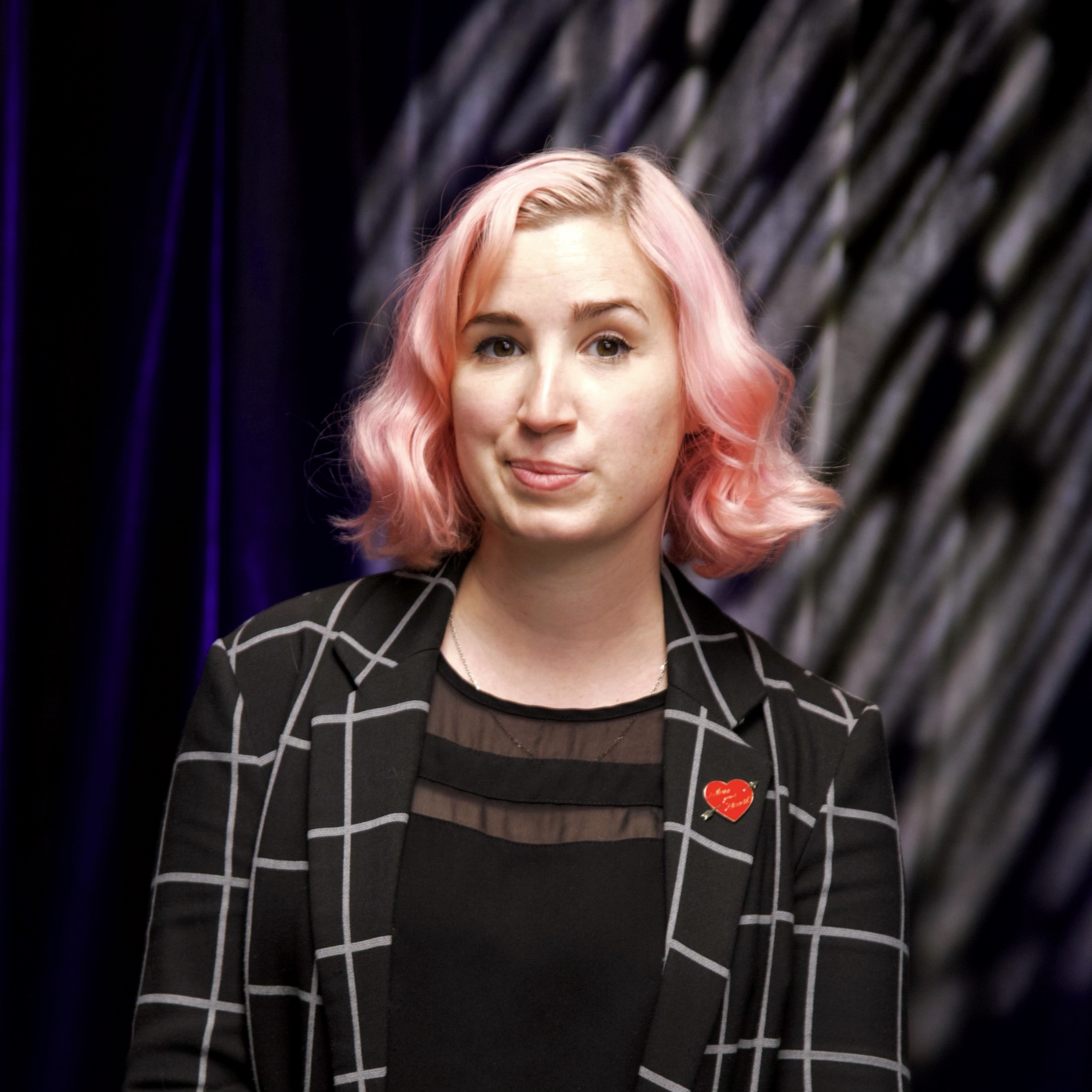 Portrait of Roxanne McDanel. Girl with pink hair wearing a window pane black blazer